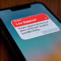 Smartphone displaying a low balance notification